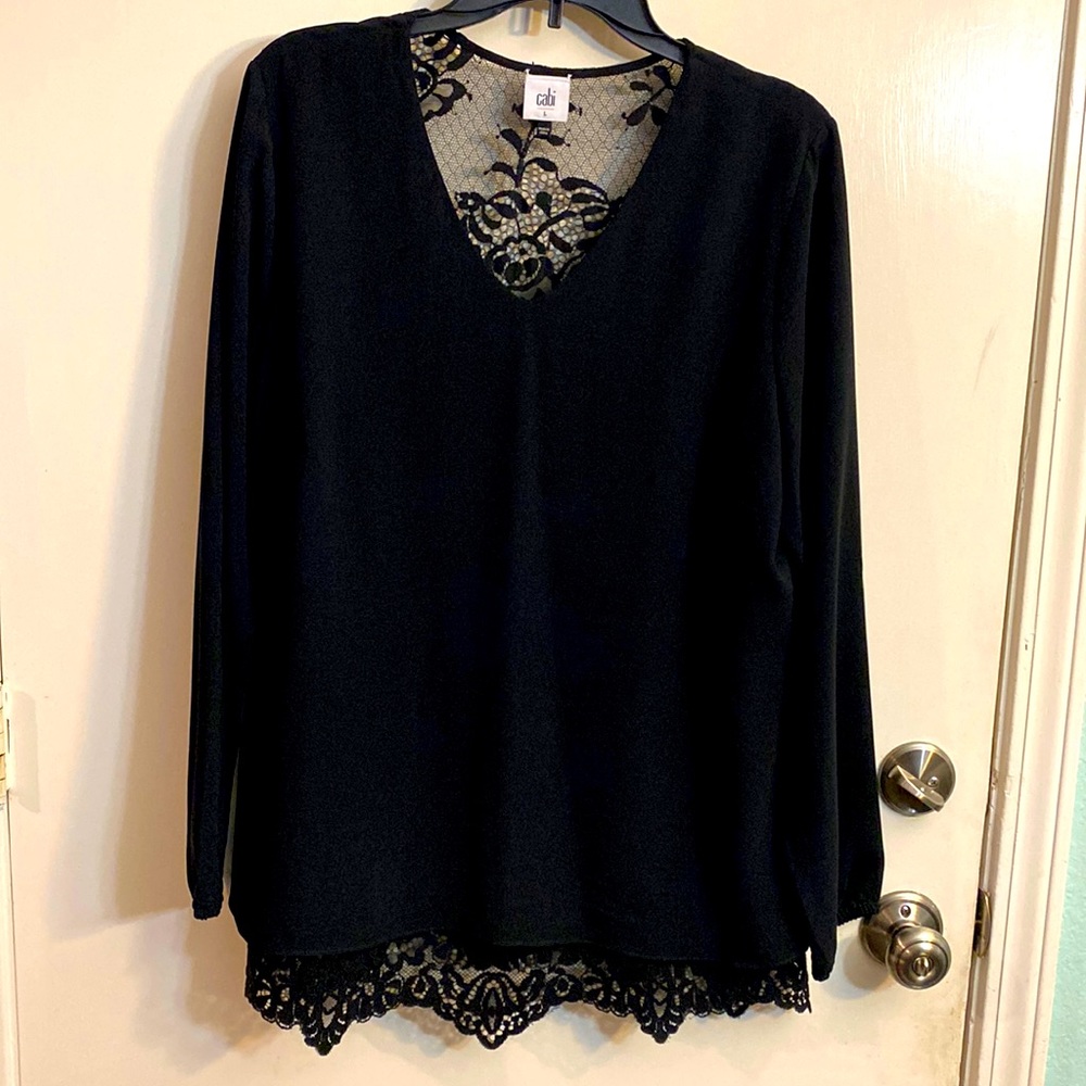 Black long sleeved dressy blouse. Layered with laced back and bottom trim.